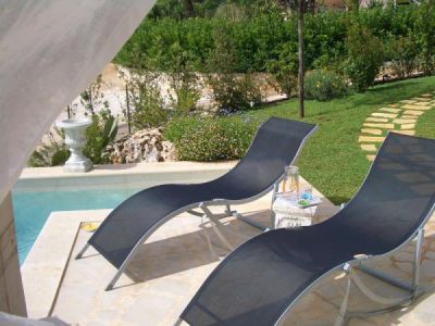 Sunbeds beside private swimming pool