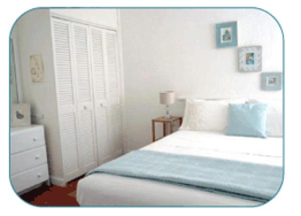 Cool white and turquoise bedroom.