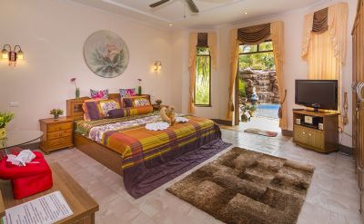 Bedroom with view of pool and waterfall