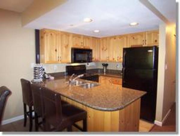 Kitchen With Granite Counters and New Applianc