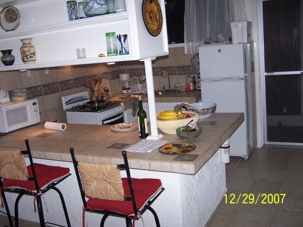 View of the fully equiped kitchen from living room