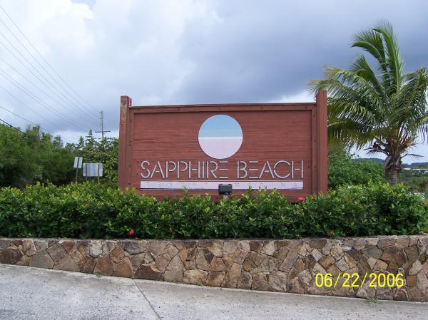 Resort Sign by Road at Entrance on Hill