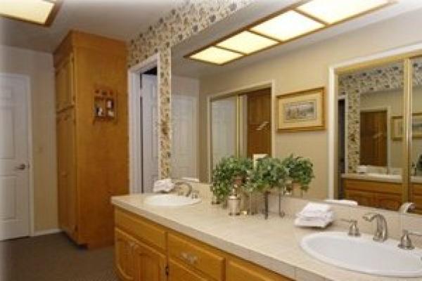 Bathroom two sinks, door into shower & toilet