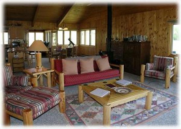 A cozy living room adjoins the kitchen & dining