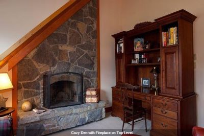 Cozy den with fireplace on top level