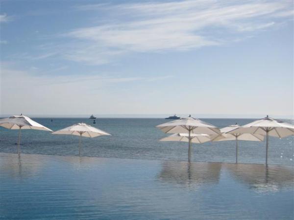 Looking across Infinity Pool at Umbrellas in Sand