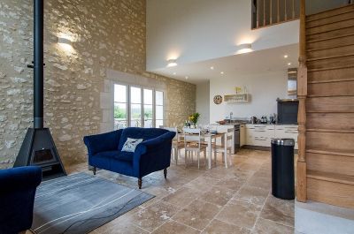 Sitting area with sofas and log fire featuring original stronework