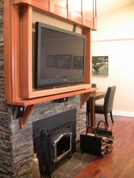 Disapearing HDTV home theater over fireplace