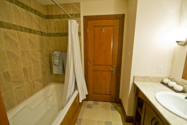 Second bathroom with bath tub and shower combinati
