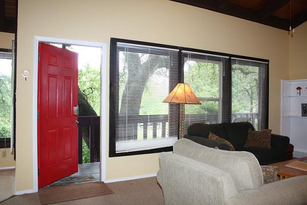 The open living/dining area has walls of windows 
