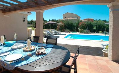 Pergola terrace with dining area and view of pool