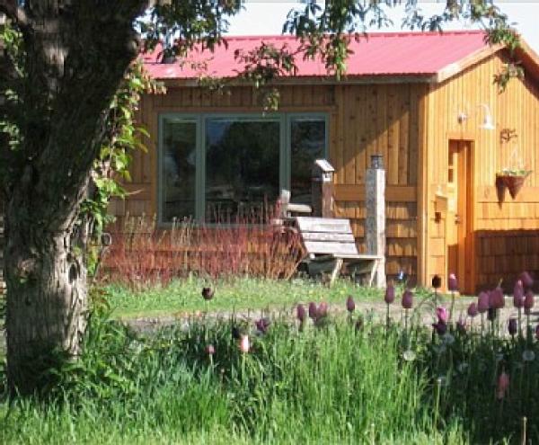 The cabin has gardens around it