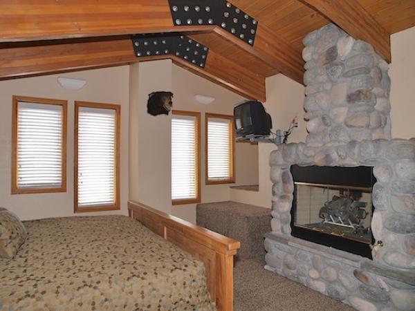 Grand Master Suite (rock fireplace, TV, open bath)