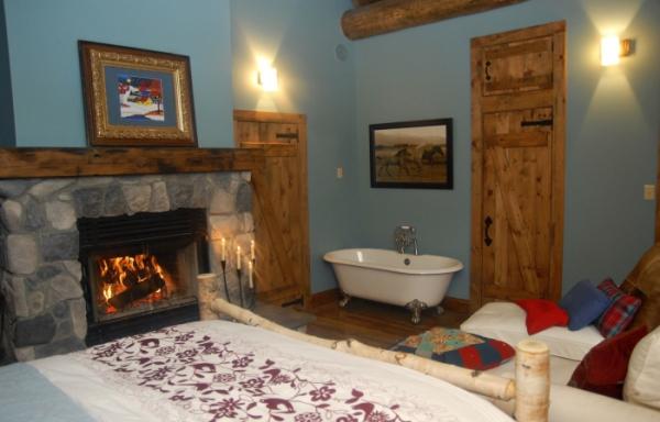 Master bedroom with two chaise wood fireplace