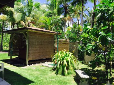 Hot tub and outdoor shower in gazebo in yard