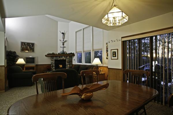 Open dining/living area with cozy hearth