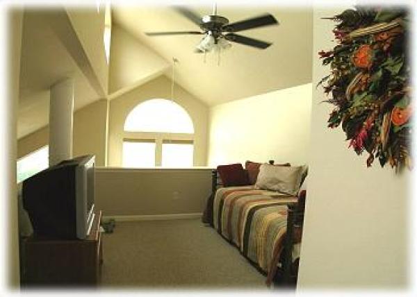 Upstairs Loft Area with Television and a Bed