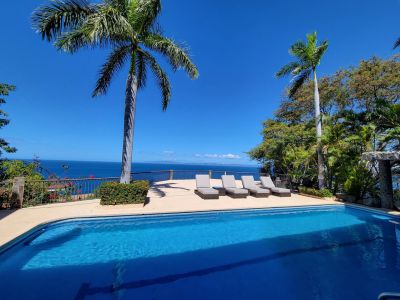 Pool with sun loungers and view of Ocean