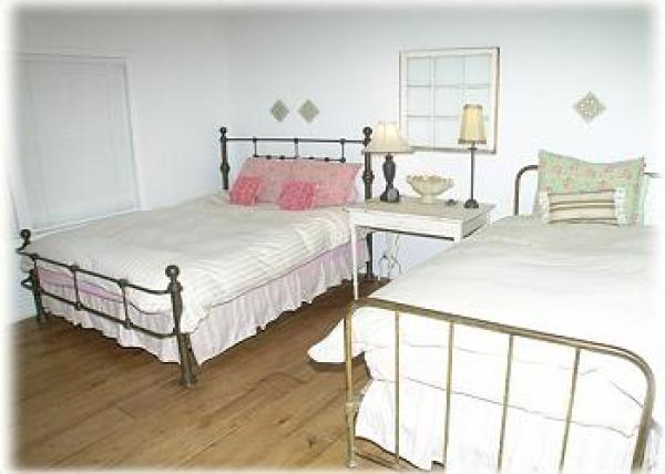 The second bedroom, with a double and a twin bed