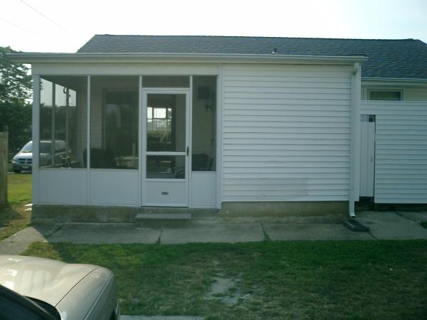 Back of house showing screened in porch and shower