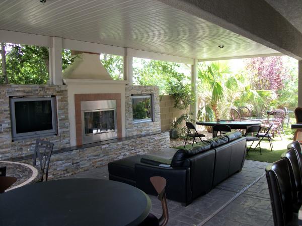 Back yard, patio area, tvs, and bar area.. 