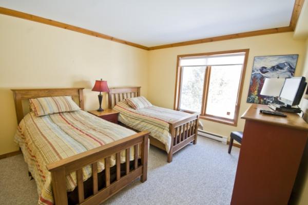 Third bedroom with two single beds and flat screen