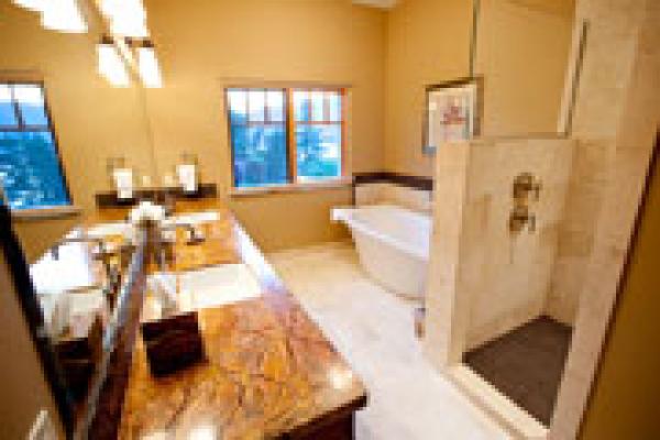 Bathroom has tile shower, counters and floors