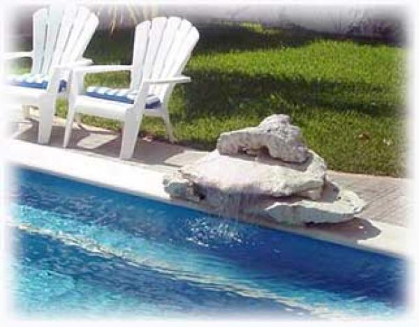 Water from the fountain gently pours into the pool