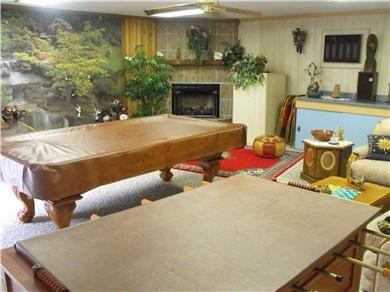 Playroom with foosbal, billiards and fireplace