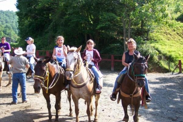 Kim horse riding on nearby mountain trail.