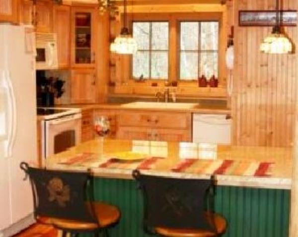 Kitchen w/ granite topped prep/eating island.