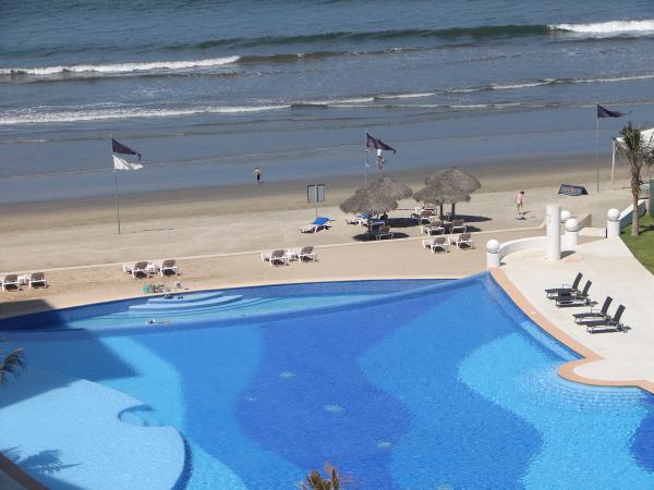 Infinity Pool Ends At  Sandy Beach and Ocean