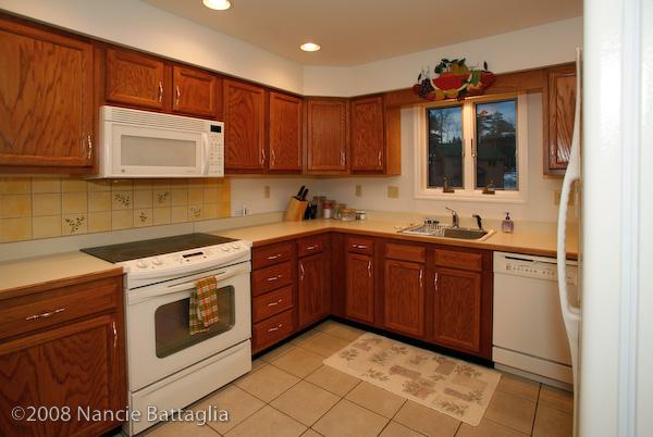 Modern kitchen has cookware & appliances