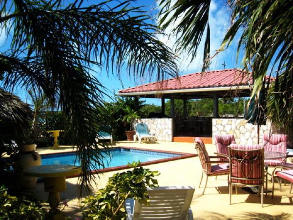 Lush vegetation surrounds our pool area.
