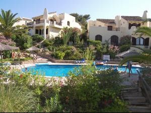 Detached villa with view of pool from sun terrace