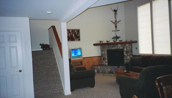 Fireplace with totem sculpture,stairs to 2nd floor