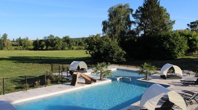 Swimming pool and toddlers pool with covered sun loungers