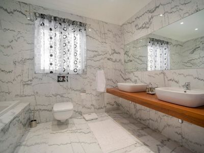 Bathroom with white marbled tiles
