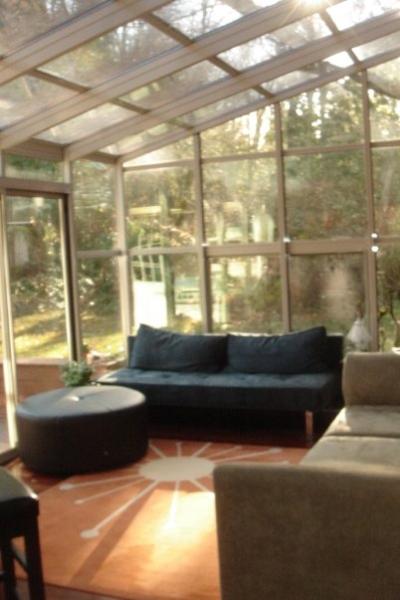 Sunroom looking out to gardens, and trail to park